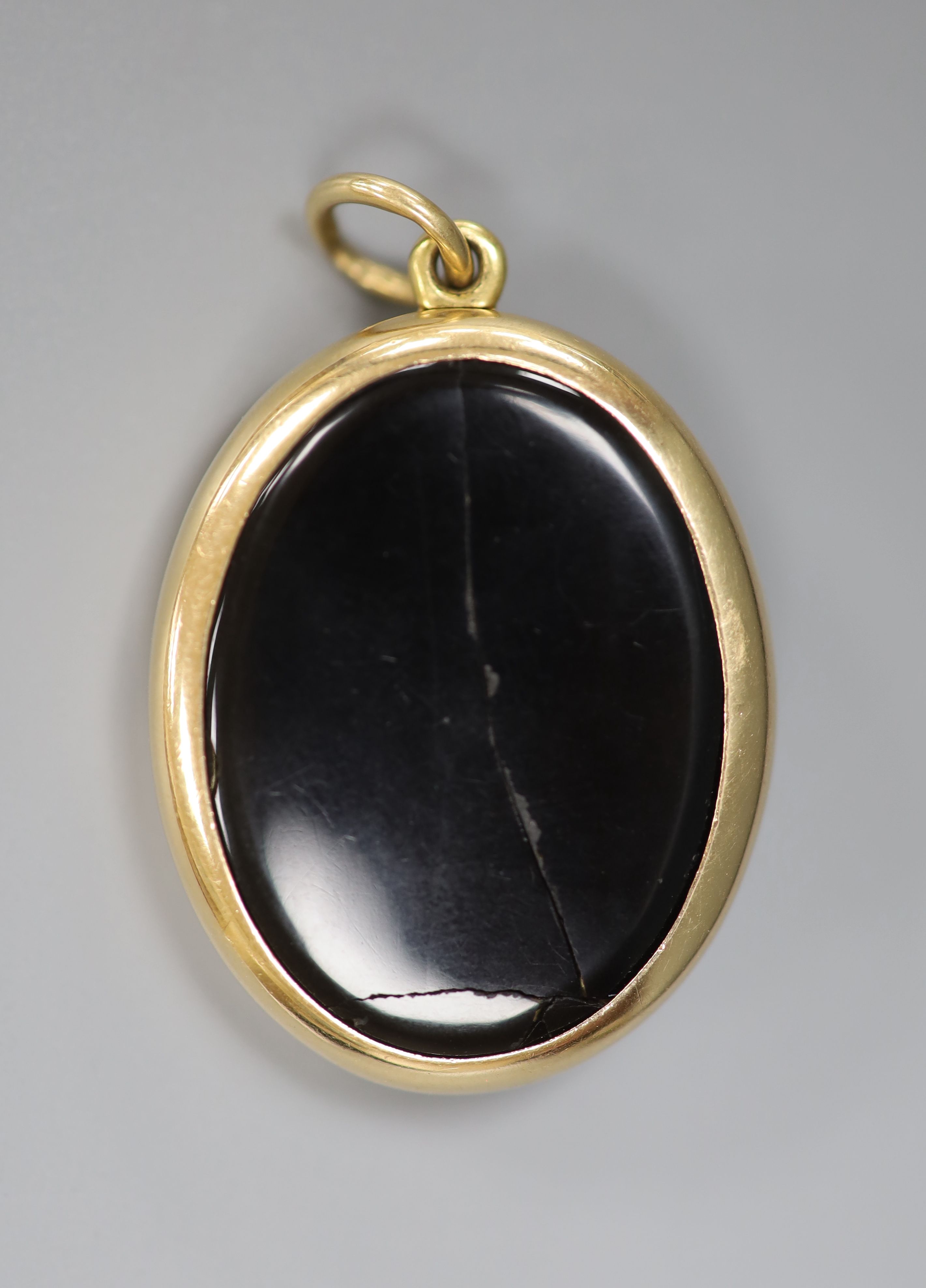 A Victorian Dublin oval yellow metal black enamel and split pearl set locket (Irish by family repute) (a.f.), 33mm, gross 17 grams.